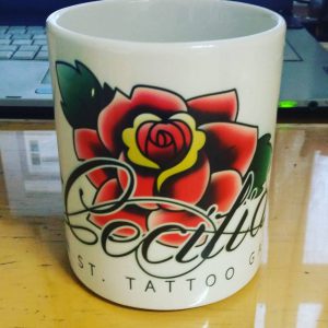 Cecilia's Main St. Tattoo Gallery logo on a mug