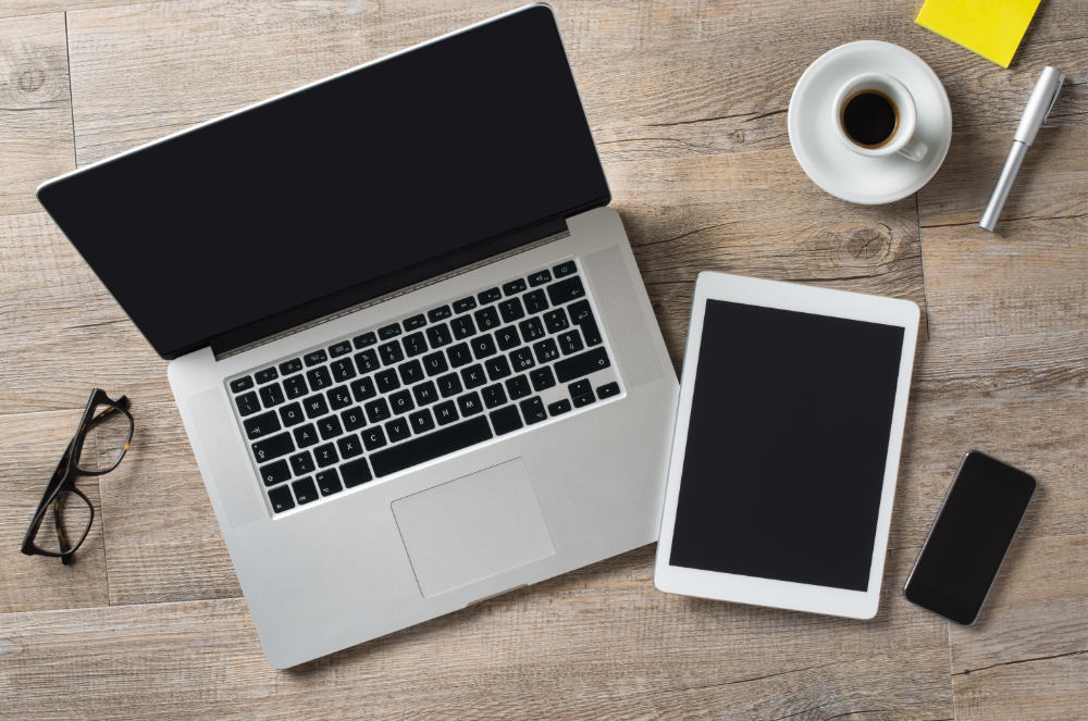 Closeup shot of laptop with digitaltablet and smartphone on desk. Modern devices on desk at office. Three different type of screen to put your responsive web page on.
